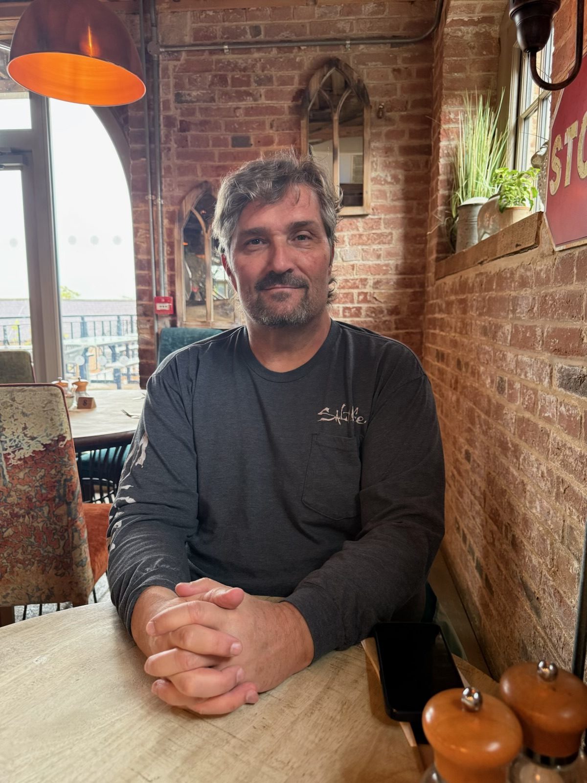 Dr. Nick Freeman seated at a café table